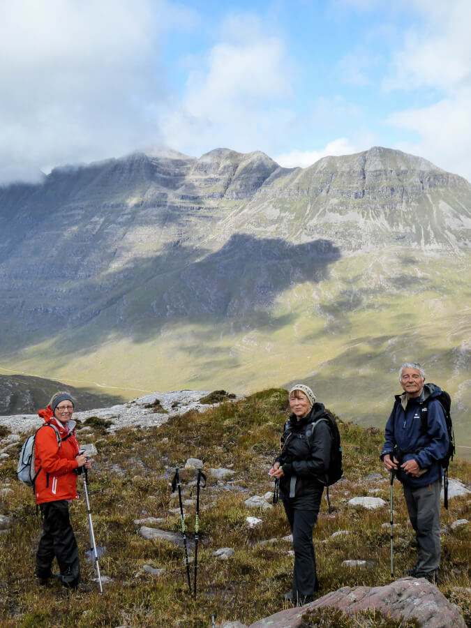 Three hikers admire Scotland's mountains